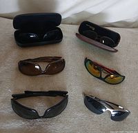 Group shot of all 6 sunglasses and 2 cases