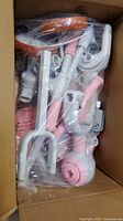 Bagged tricycle stroller parts inside carton