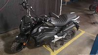 Left-front view of matte dark gray/black Warrior electric scooter