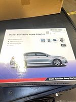 Front of boxed multi-function jump starter showing product graphics and title