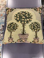 Front view showing tapestry design of citrus topiary trees