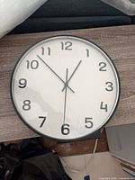 Front view of clock showing face, numerals, and hands