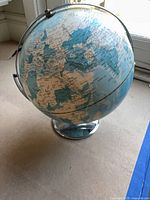 Globe on chrome stand showing Europe, Asia, Africa