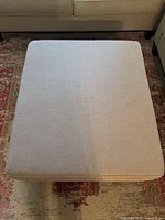 Top view of square beige ottoman surface