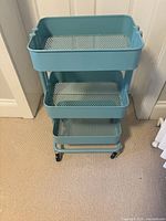 Front view of full cart showing three tiers and casters