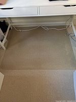 Mat positioned under desk showing overall size and transparency