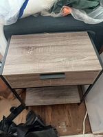 Front view of side table showing drawer closed and lower shelf