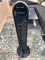 Full view of black Garrison tower fan on base