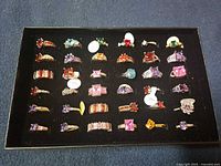 Tray showing 36 assorted .925 silver rings with colored stones