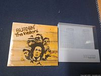 Front cover artwork and silver slipcase of the deluxe edition set