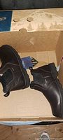 Full pair of boots in box, tags visible