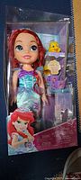 Front view of sealed box showing Ariel doll, Flounder figure and tea accessories