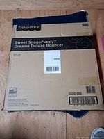 Closed original Fisher-Price shipping carton showing product name and model barcode