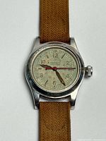 Front view of watch without crystal showing dial, hands, case, strap