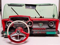 Full view of toy dashboard showing windshield, steering wheel, gauges and controls