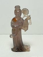 Front view of carved lavender jade woman figure