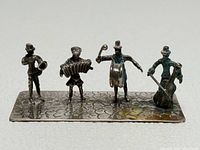 Front view showing all four musicians on cobblestone base