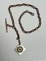 Full view of pocket watch chain with compass fob and T-bar
