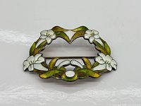 Front view of sterling silver brooch showing enamel floral design
