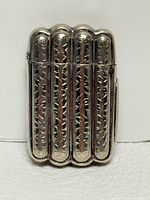 Front view of sterling silver match safe shaped as four cigars