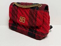 Full view of red and black plaid Balenciaga BB wool shoulder bag showing logo and shape