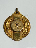 Obverse showing hockey player motif and laurel detailing