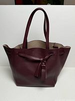 Full view of Celine burgundy Cabas Phantom tote bag standing upright