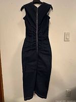 Back view of indigo denim dress showing full-length zipper and ruched seams