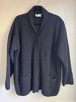 Front view showing button closure, collar, pockets, overall style