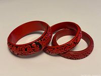 Three red cinnabar bracelets grouped