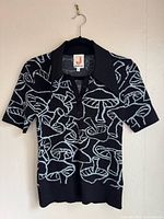 Full view of JoosTricot mushroom pattern knit polo shirt front