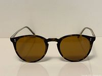 Front view of tortoiseshell round sunglasses with brown lenses