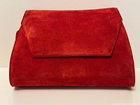 Front view of red suede Calderone clutch bag