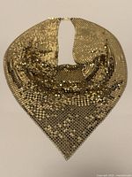 Front view of gold-tone mesh cowl necklace laid flat