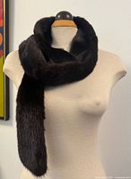Front view of long dark brown mink fur collar wrapped on mannequin
