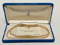 Necklace in Birks box with business card