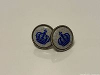 Front view showing blue crown design on both cufflinks