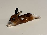 Front angled view of reclining rabbit figurine