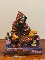 Front view of Royal Doulton The Potter figurine with surrounding pots