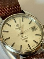 Close-up of dial showing brand, model, date window and condition