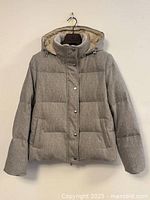 Full view of grey Eleventy puffer coat front hanging