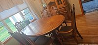 Dining table with six chairs around it