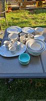 Full assortment of Pfaltzgraff dinnerware displayed on table