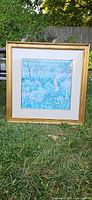 Monet replica print in gold frame on grass