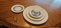 Stacked dinnerware showing pattern and missing one cup