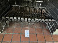 Full view of cast iron fireplace grate inside firebox