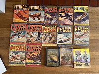 Top view showing 12 Flying Aces magazines, two hardcovers, and R. Crumb book