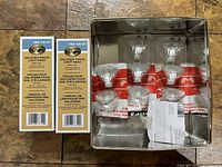 Two Hampton Bay track light head boxes, nine halogen bulbs in tin