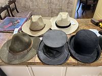 All five hats displayed together on countertop