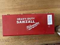 Red metal case lid marked Heavy-Duty Sawzall Milwaukee